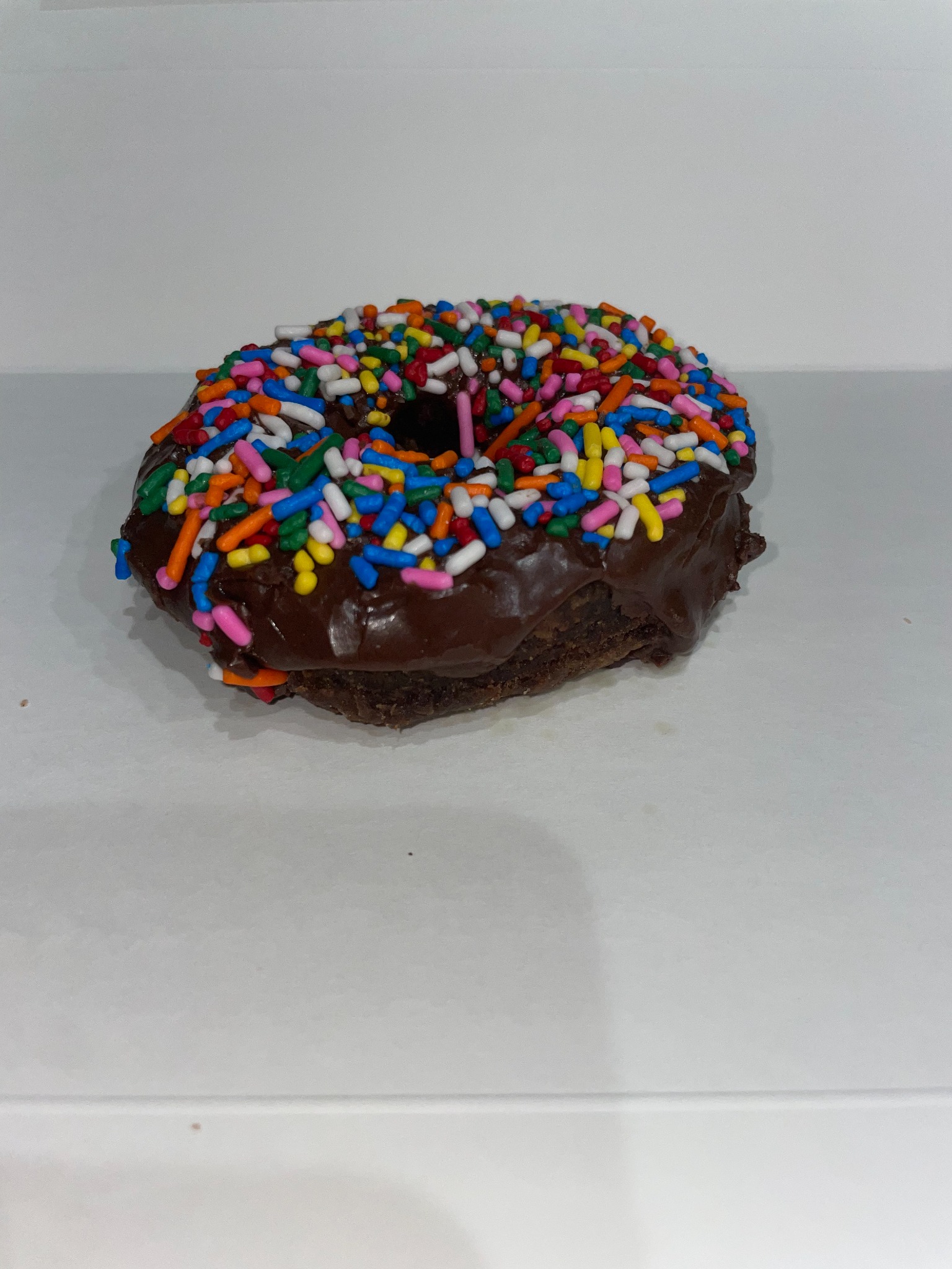 Our chocolate cake donut with chocolate icing and rainbow sprinkles